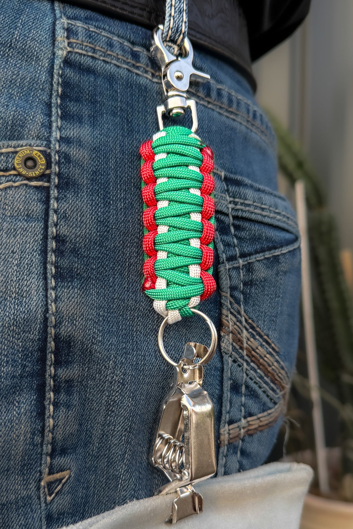 OLTX México paracord glove clip in green / white / red attached to a belt loop