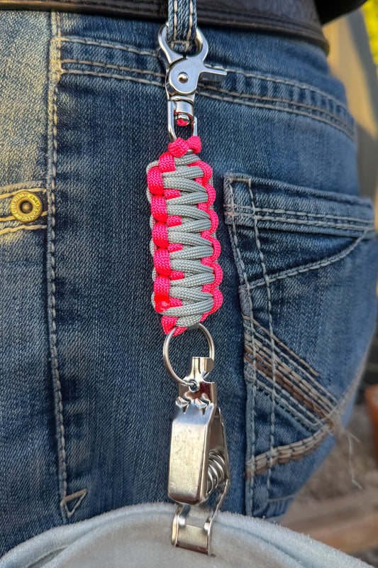 OLTX Pink Steel paracord glove clip in gray / hot pink attached to a belt loop