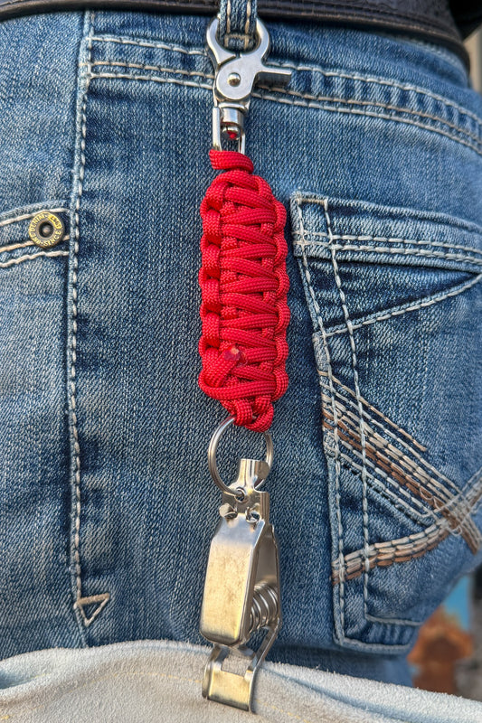 OLTX Torch Red paracord glove clip in red attached to a belt loop
