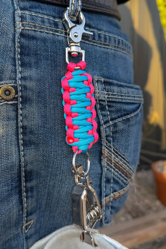 OLTX Vice paracord glove clip in turquoise / hot pink attached to a belt loop